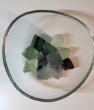 Various sizes of Fluorite crystals in their natural diamond shape in various colours ranging from green, light green, purple, and clear.