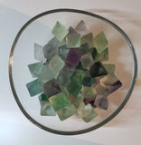 Various sizes of Fluorite crystals in their natural diamond shape in various colours ranging from green, light green, purple, and clear.