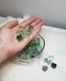 Various sizes of Fluorite crystals in their natural diamond shape in various colours ranging from green, light green, purple, and clear.